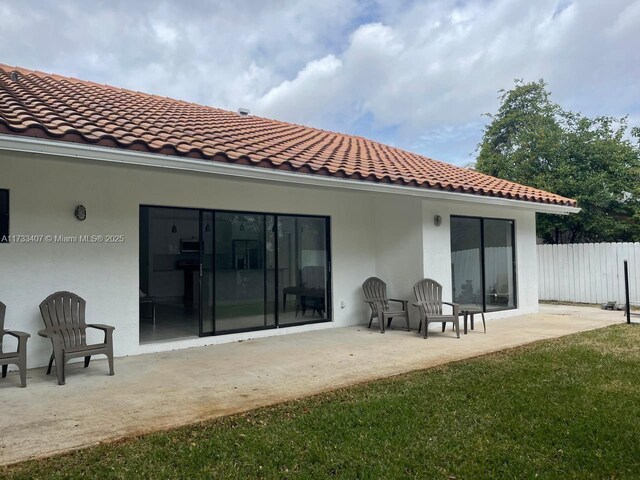 back of house with a yard and a patio area