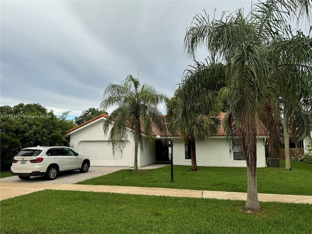 mediterranean / spanish-style home with a garage and a front yard