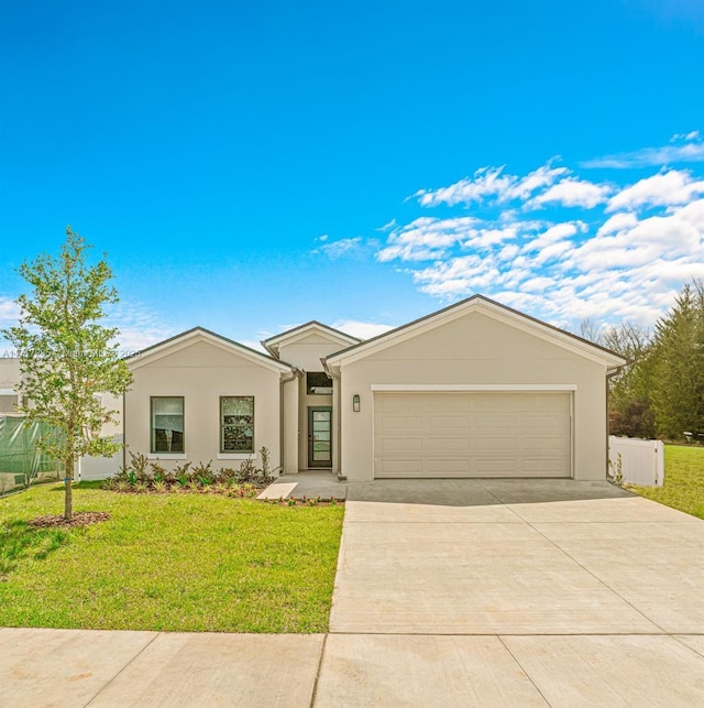 single story home with a garage and a front lawn