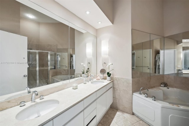 bathroom featuring tile patterned floors, independent shower and bath, and vanity