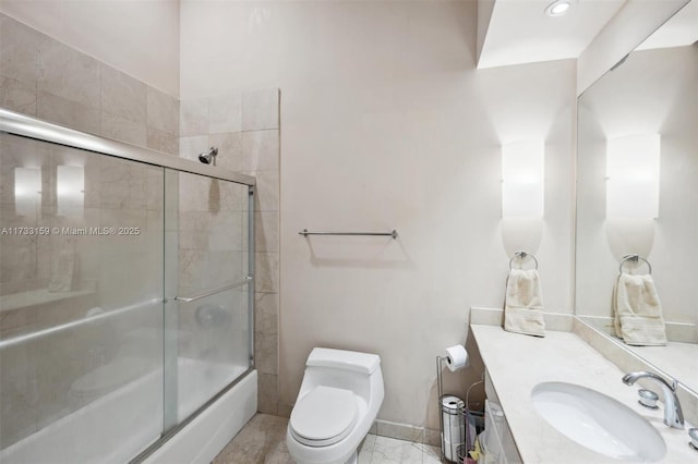 full bathroom featuring toilet, vanity, and bath / shower combo with glass door