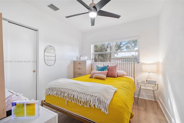 bedroom with ceiling fan and light hardwood / wood-style floors