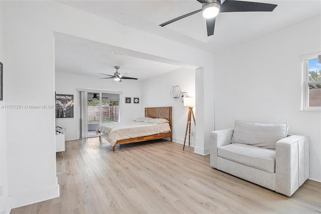 bedroom with multiple windows, ceiling fan, access to exterior, and light wood-type flooring