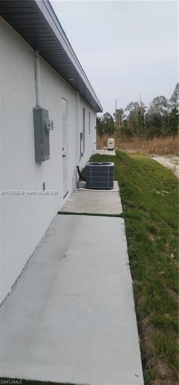 view of side of home featuring cooling unit