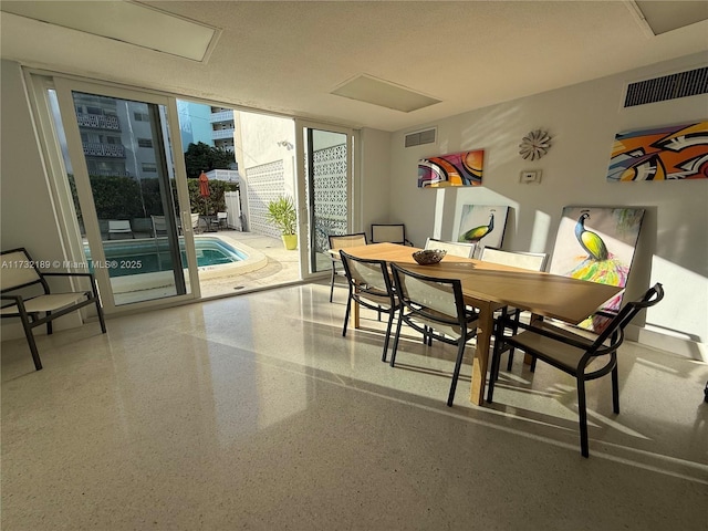 dining area featuring a wall of windows