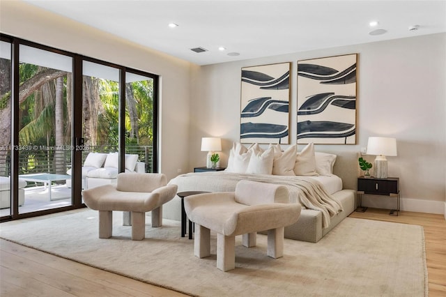 bedroom featuring light hardwood / wood-style floors and access to outside