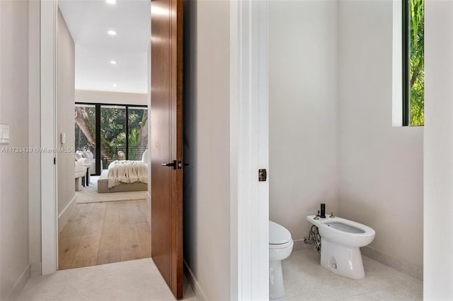 bathroom with a bidet and toilet