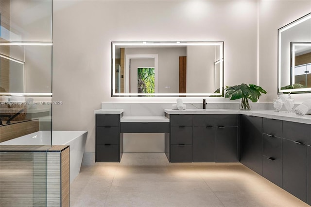 bathroom featuring tile patterned flooring, a bathing tub, and vanity