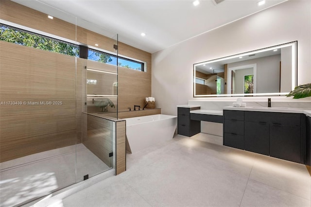 bathroom with independent shower and bath and vanity