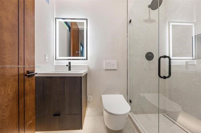 bathroom featuring vanity, a shower with door, and toilet