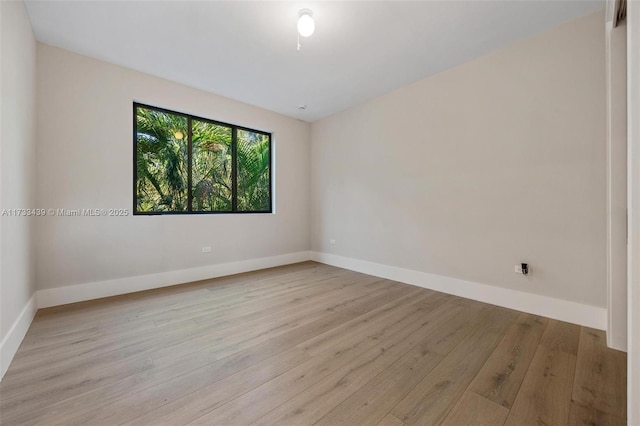 empty room with light hardwood / wood-style flooring