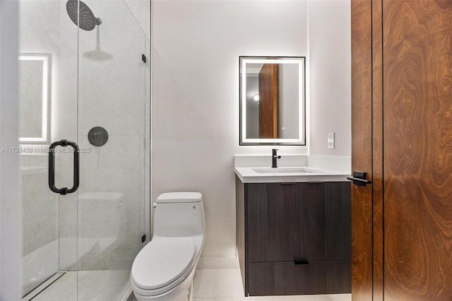 bathroom featuring vanity, a shower with shower door, and toilet