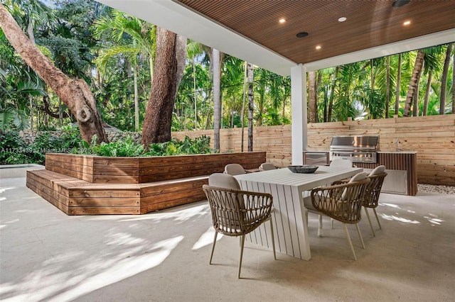 view of patio / terrace featuring exterior kitchen and a grill