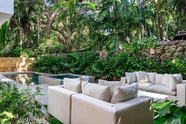 view of patio featuring a pool with hot tub and an outdoor hangout area