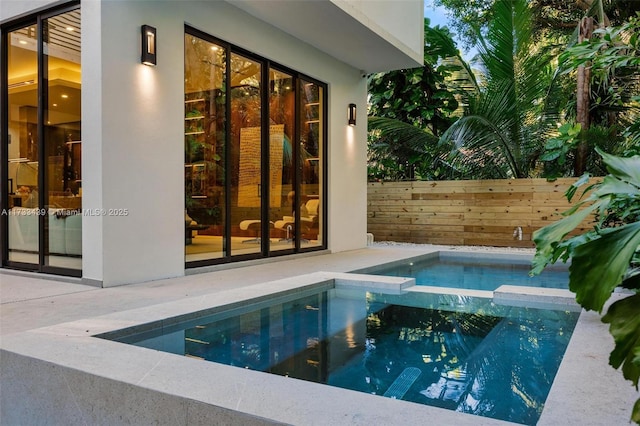 view of swimming pool with an in ground hot tub