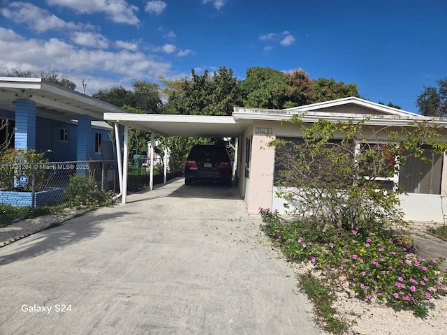 view of parking / parking lot with a carport