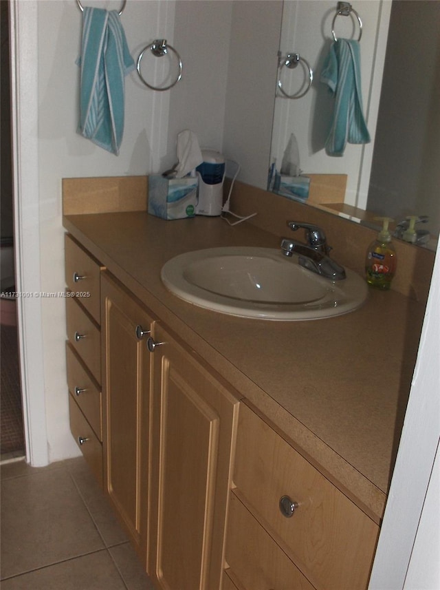 bathroom featuring tile patterned flooring and vanity