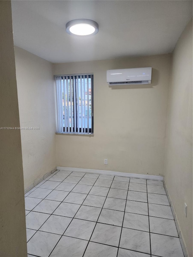 tiled empty room featuring a wall mounted AC