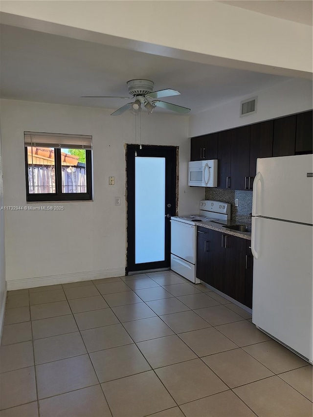 kitchen with light tile patterned flooring, white appliances, ceiling fan, and decorative backsplash