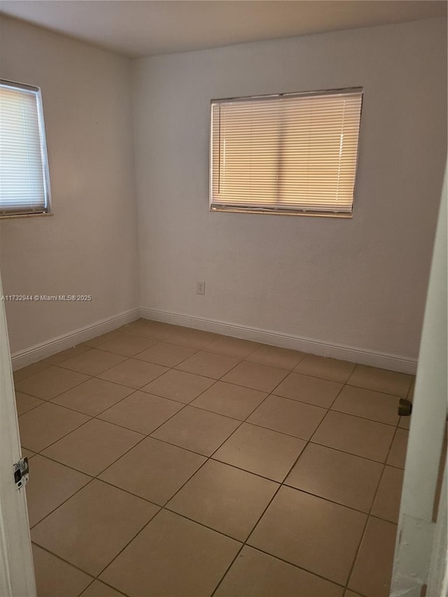 spare room featuring light tile patterned floors