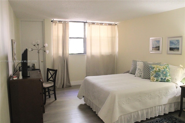 bedroom with hardwood / wood-style flooring