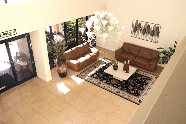 tiled living room featuring an inviting chandelier