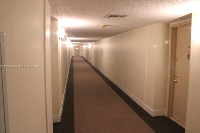 hallway featuring a textured ceiling