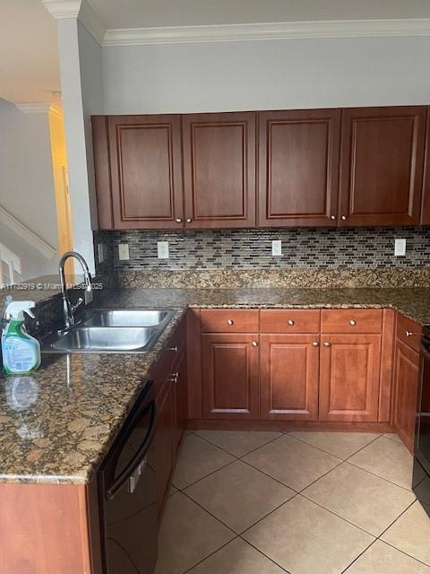 kitchen featuring backsplash, dishwasher, sink, and light tile patterned floors