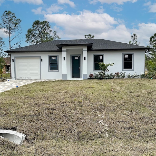 view of front facade with a garage and a front lawn