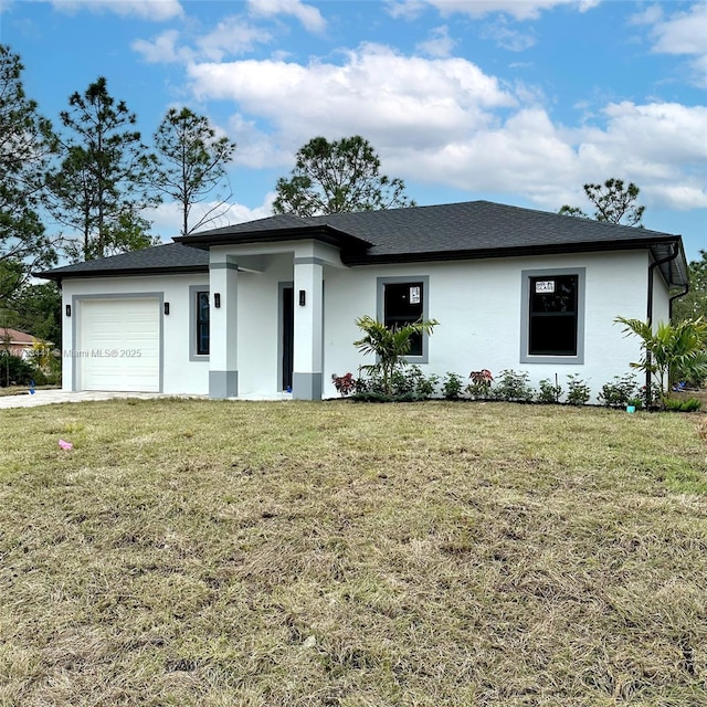 view of front of property featuring a garage and a front yard