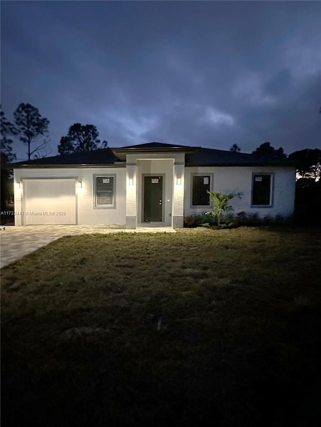 view of front facade with a garage and a front lawn