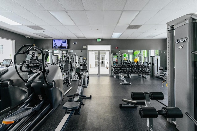 gym featuring french doors and a drop ceiling