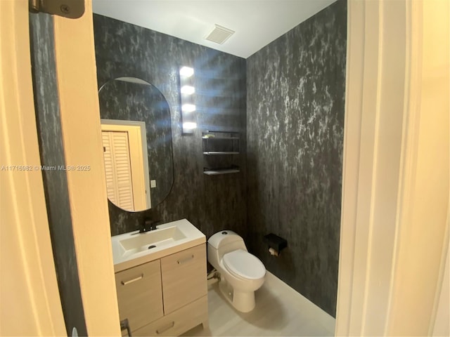 bathroom with vanity and toilet