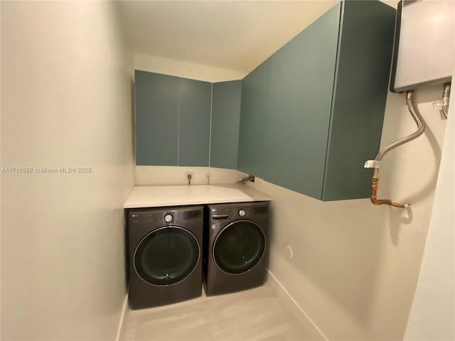 laundry area with cabinets and washing machine and dryer