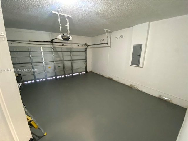 garage featuring a garage door opener and electric panel