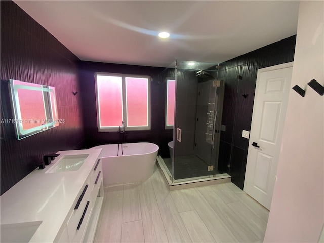 bathroom featuring vanity, hardwood / wood-style flooring, and independent shower and bath