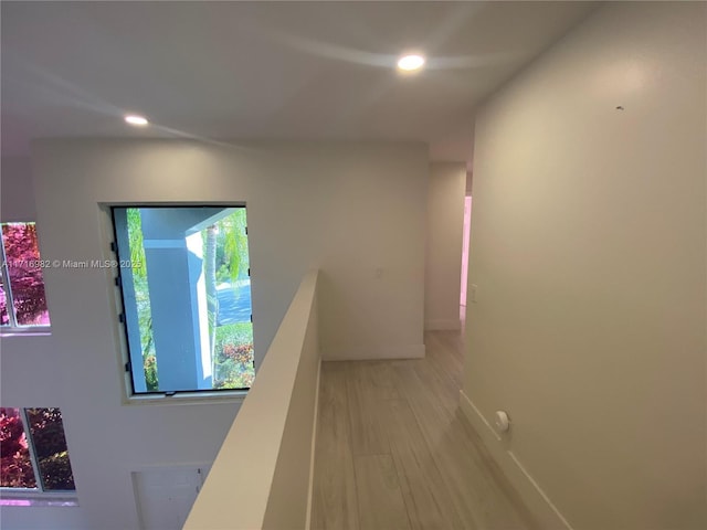 hallway with light hardwood / wood-style floors