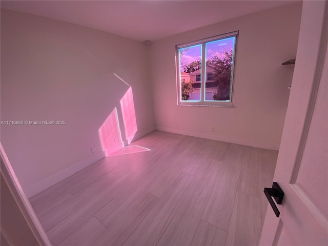 empty room with light hardwood / wood-style flooring