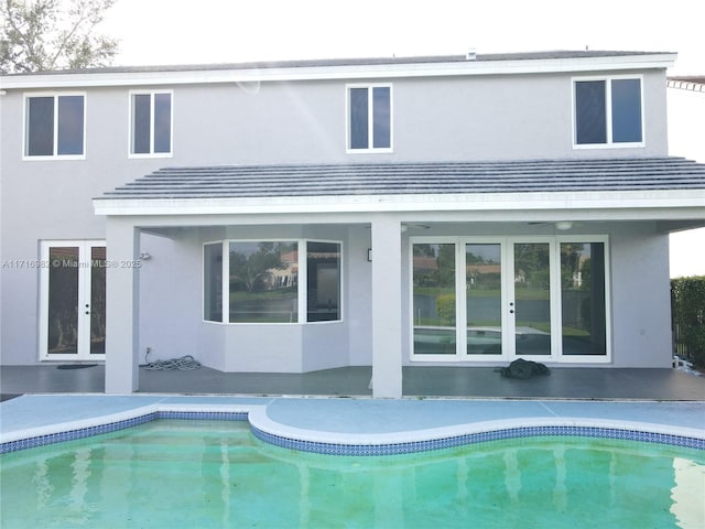 rear view of property with french doors