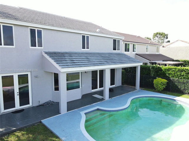 view of pool with a patio and french doors