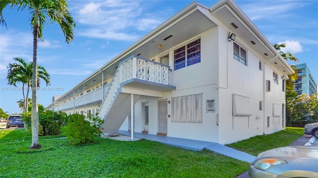 exterior space featuring a yard and a balcony