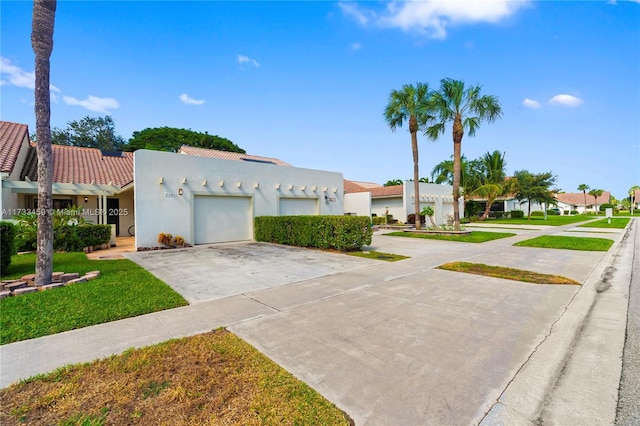 view of front of house with a garage and a front yard