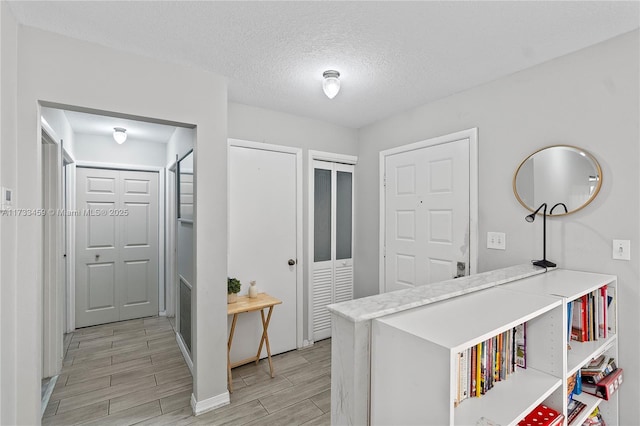 hallway with a textured ceiling