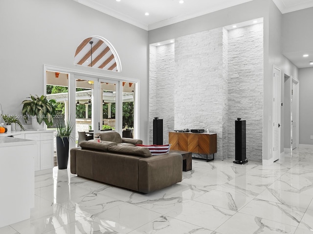 living room featuring a towering ceiling and ornamental molding