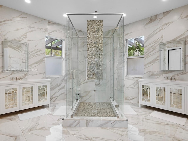 bathroom featuring walk in shower, vanity, and tile walls