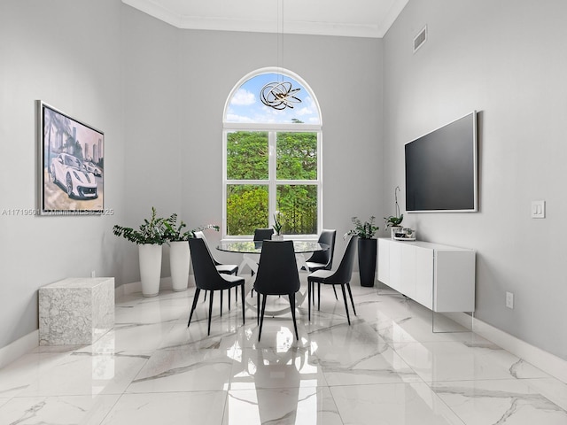 dining space with crown molding