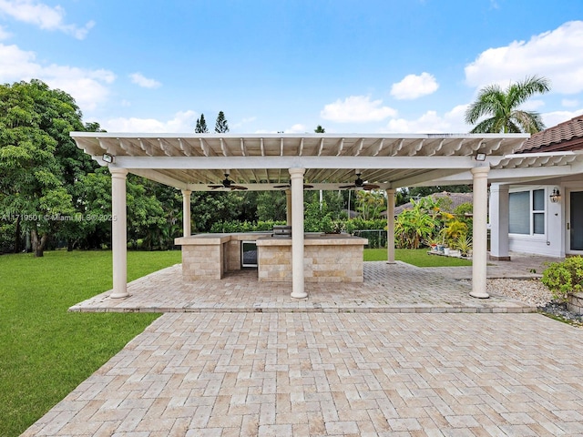 view of patio / terrace with an outdoor kitchen, a bar, ceiling fan, and a pergola