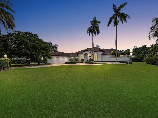 yard at dusk with a garage