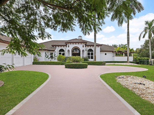 view of front of house featuring a garage and a front lawn