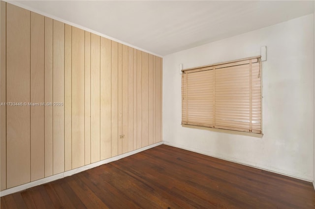 empty room with dark wood-type flooring